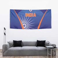 Blue India cricket tapestry on wall behind gray couch, orange border and INDIA text