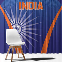 Blue curtain close-up with large India lettering, Ashoka wheel motif, and orange diagonal lines