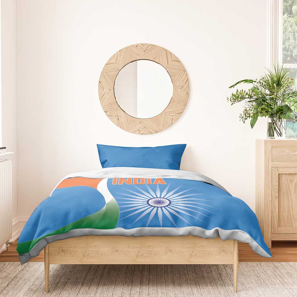 Blue duvet cover and pillowcases with INDIA text and tricolor sunburst on wooden bed