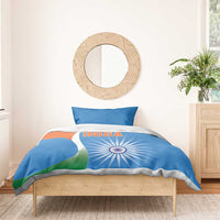 Blue duvet cover and pillowcases with INDIA text and tricolor sunburst on wooden bed