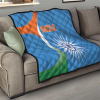 Blue cricket quilt blanket on sofa with India text, sunburst wheel, orange-white emblem, and green corner
