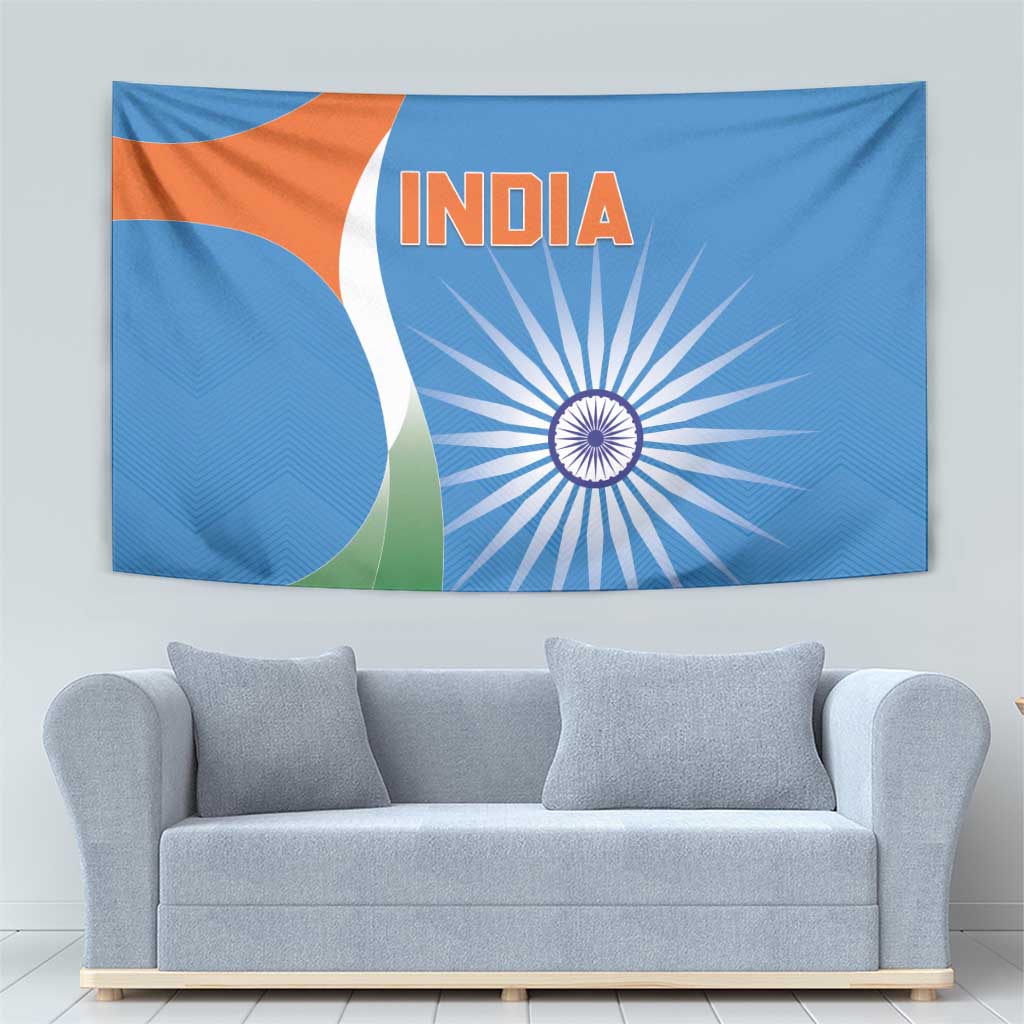 Blue India cricket tapestry with orange INDIA lettering and white spoked wheel design.