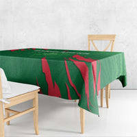 Green cricket tablecloth corner with bold red striped design