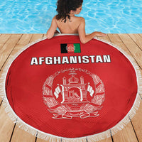 Red circular Afghanistan beach blanket with white fringe, “AFGHANISTAN” and ornate crest