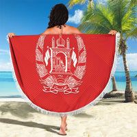 Red round Afghanistan beach blanket with white fringe, large central crest and Arabic script