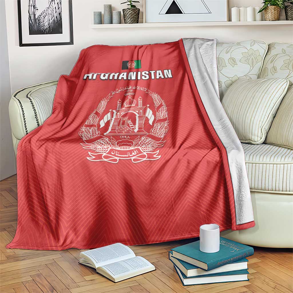 Red Afghanistan flag cricket blanket with white crest and “AFGHANISTAN”, draped on sofa