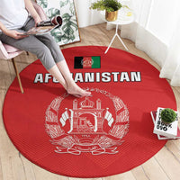 Red round rug, close-up of Afghanistan flag-style crest and 'AFGHANISTAN' text
