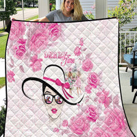Pink quilt with diamond quilting, floral print, stylized woman face graphic, black trim
