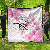Pink and white quilt with diamond quilting, floral design and stylized woman face motif, bordered