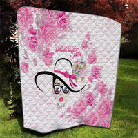Pink floral quilt with diamond stitch pattern, stylized woman face graphic, black outline