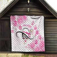 Pink and white quilt hanging outdoors, diamond quilting, floral print and stylized woman face motif