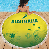 Round yellow beach blanket with green Australia emblem and star icons, white fringe trim