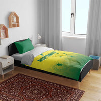 Green and yellow Australia-themed duvet on bed with two matching pillows