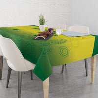 Green and yellow patterned tablecloth with circular motifs on a dining table
