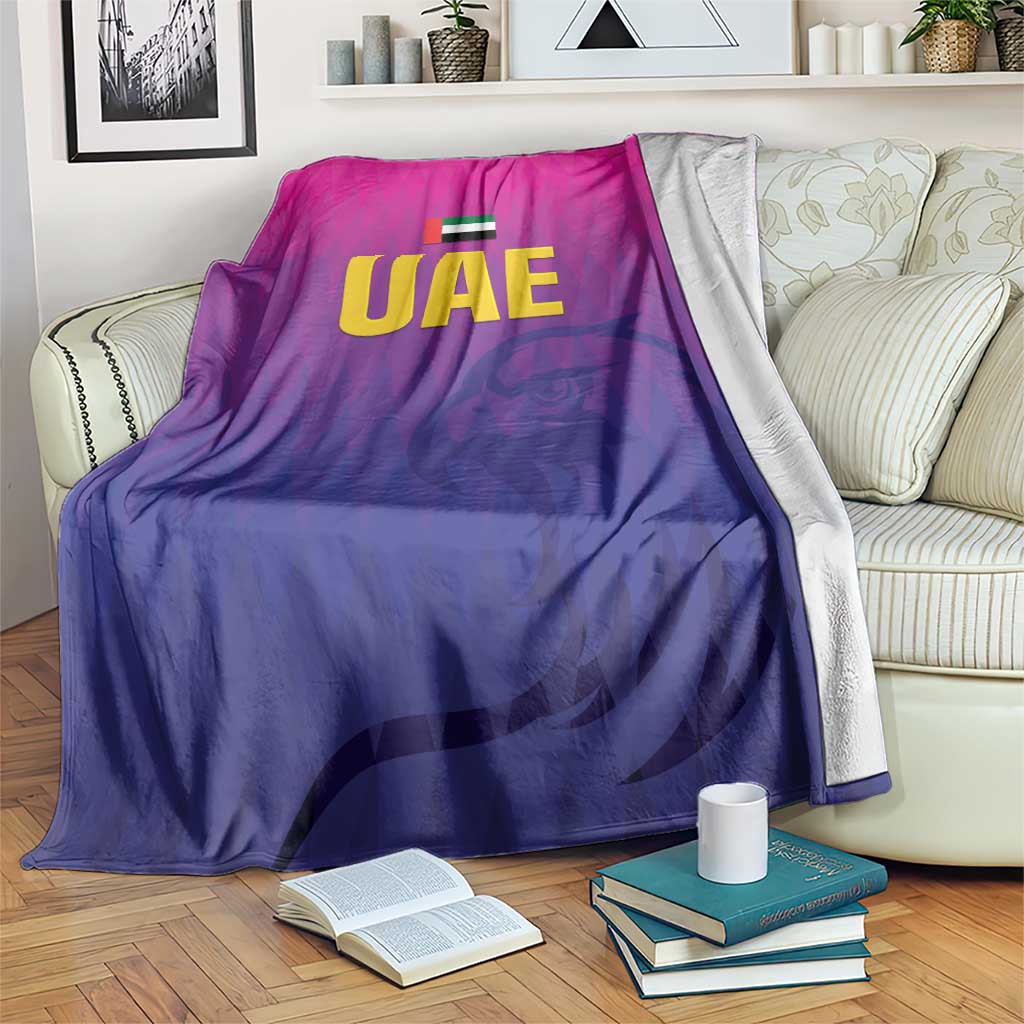 Purple UAE cricket blanket draped over sofa with UAE logo at center