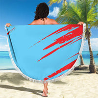 Light blue round beach blanket with red Kuwait flag stripes and KUWAIT text, white fringe