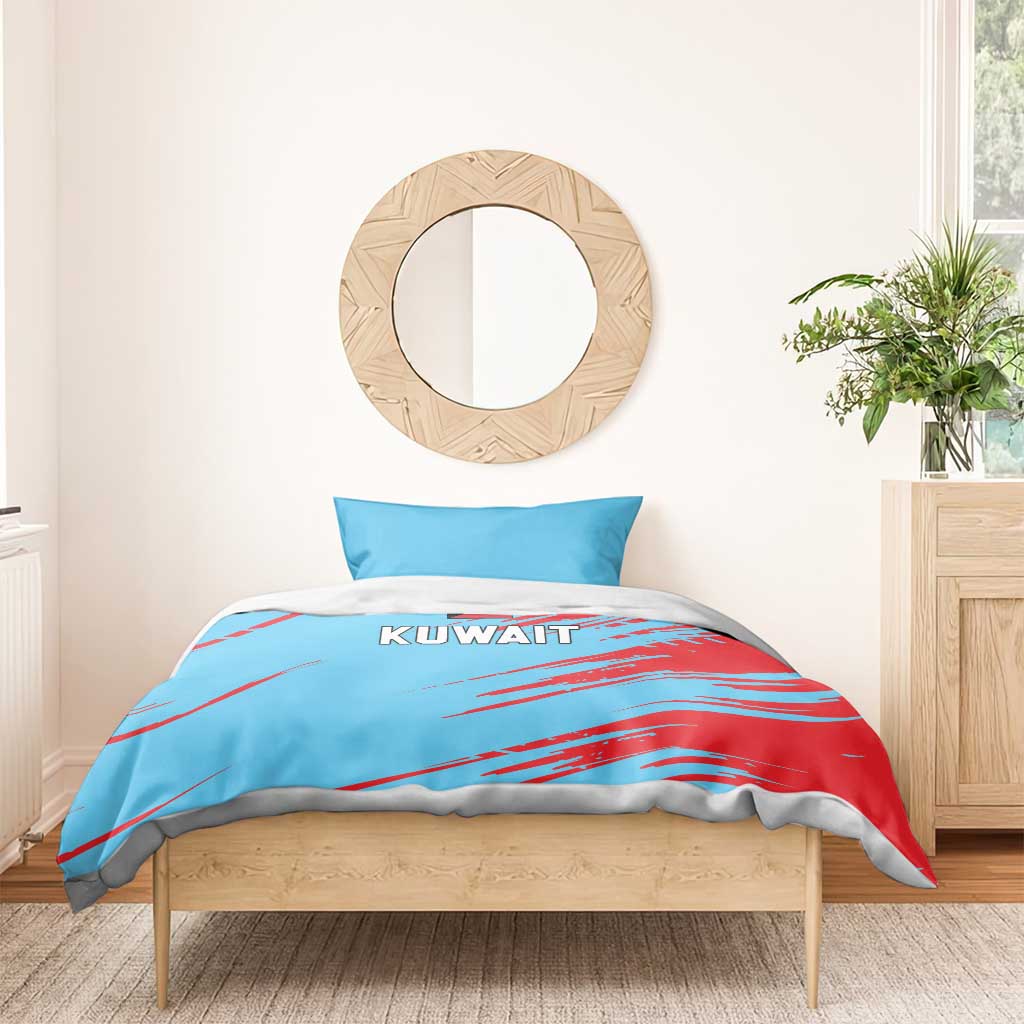 Blue duvet with red streaks and KUWAIT text, styled with a matching pillowcase.
