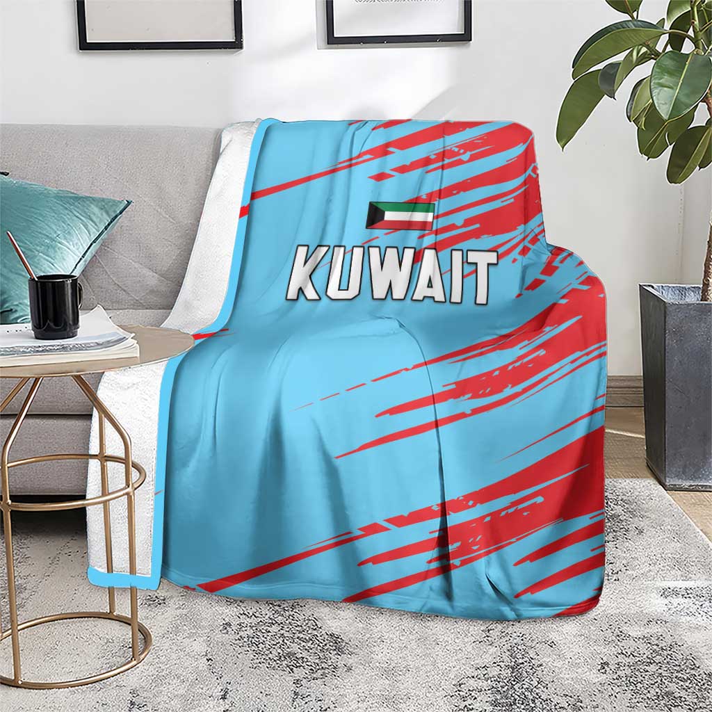 Light blue Kuwait cricket blanket with red diagonal stripes on a gray sofa