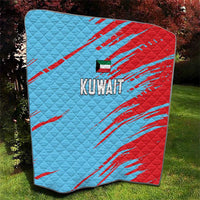 Kuwait cricket quilt outdoors, blue and red quilt with diagonal stripes and Kuwait logo.