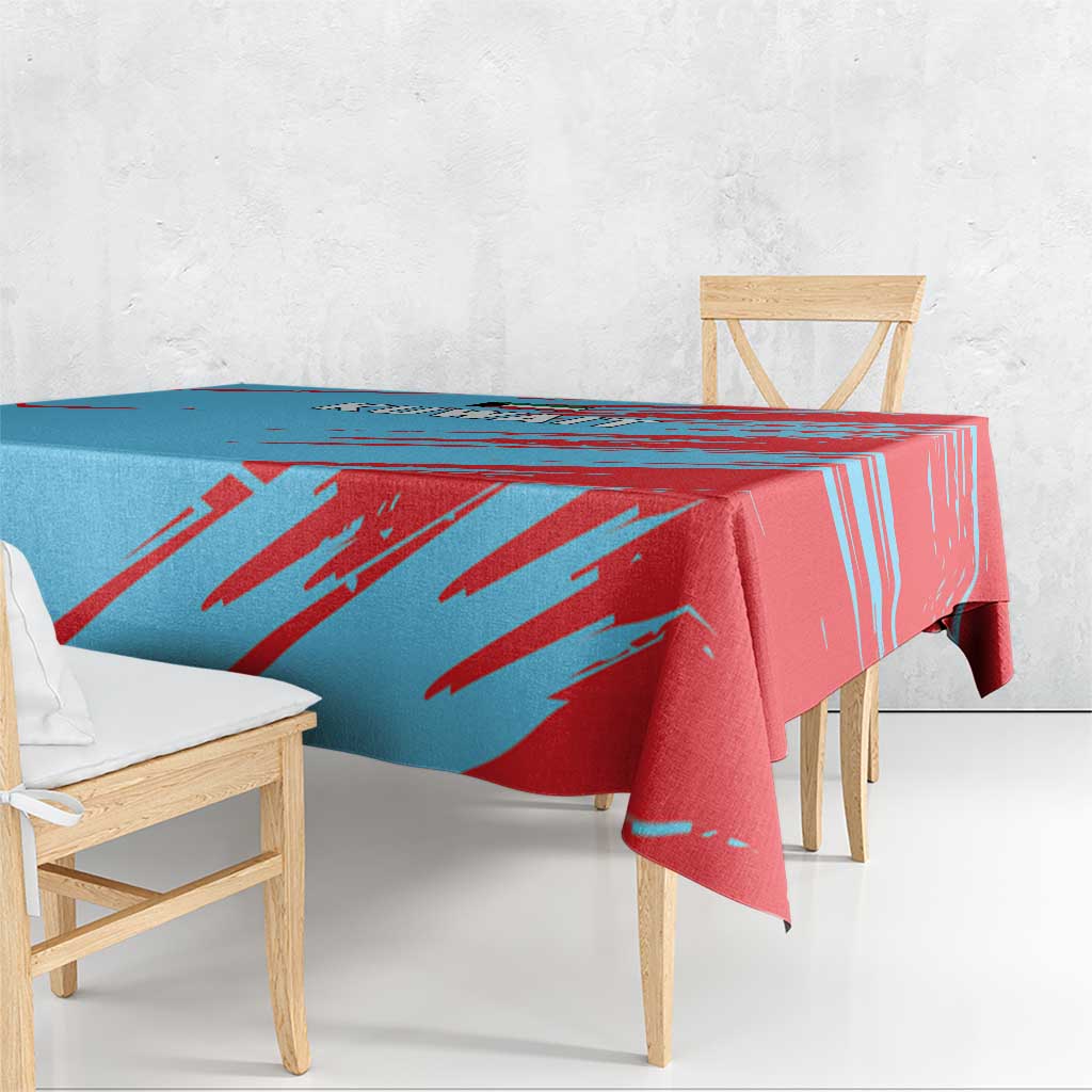 Blue and red Kuwait tablecloth with bold diagonal brushstroke stripes and folded edge
