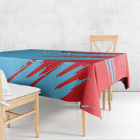 Blue and red Kuwait tablecloth with bold diagonal brushstroke stripes and folded edge