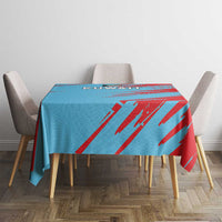 Square Kuwait-themed tablecloth in blue and red, draped over a dining table