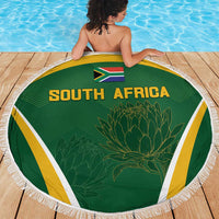 Green South Africa beach blanket, round with fringed trim, flag and protea center print