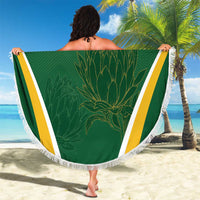 Green round beach blanket with fringed edge, yellow-white border stripes and protea graphic