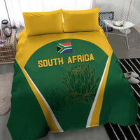 South Africa cricket bedding set on bed: green duvet with yellow border and two pillows
