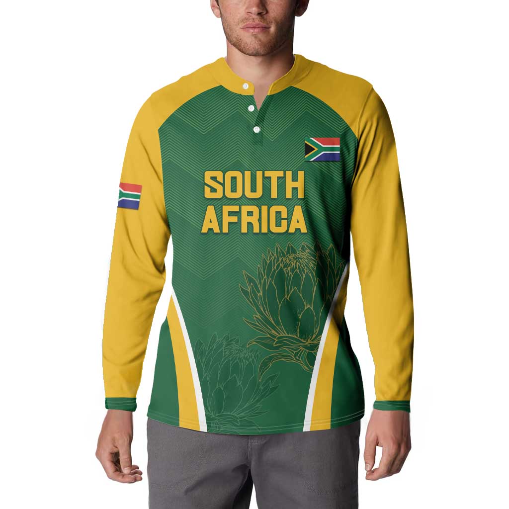 Green and yellow cricket button sweatshirt on model, South Africa text with flag patch