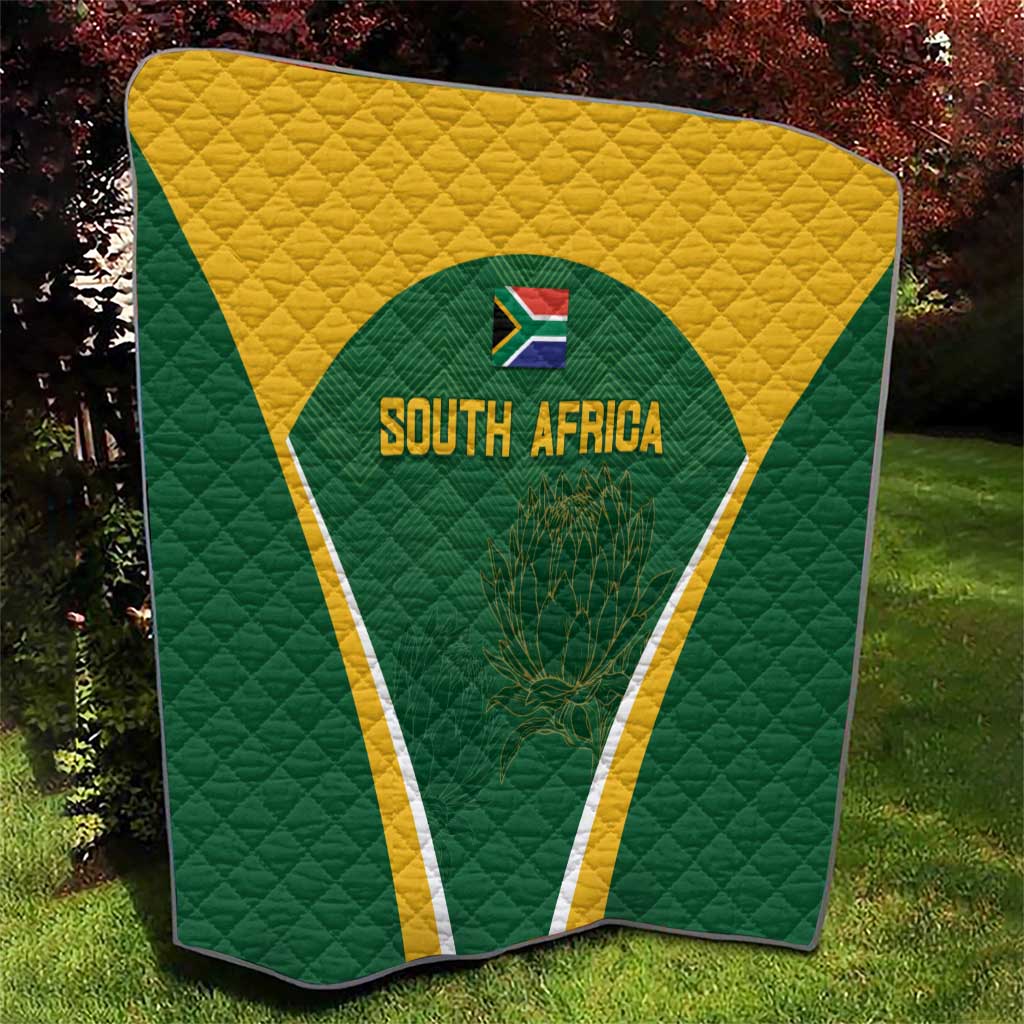 Green and yellow South Africa quilt with triangle emblem showing 'SOUTH AFRICA' and plant design