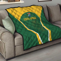 Green and yellow South Africa quilt laid on sofa with centered triangle crest and 'SOUTH AFRICA'