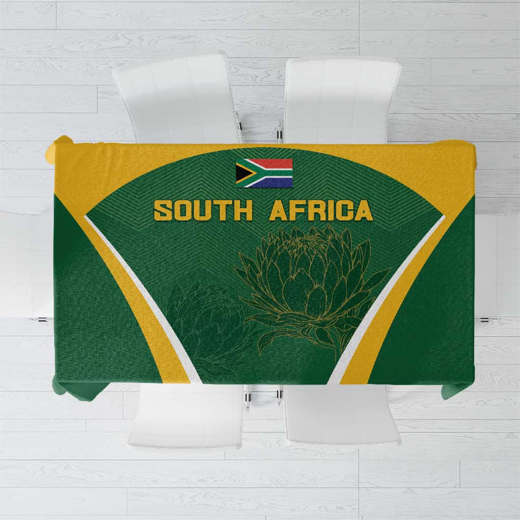 Green tablecloth with yellow and white geometric border, South Africa emblem and protea design