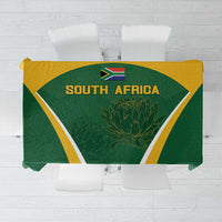Green tablecloth with yellow and white geometric border, South Africa emblem and protea design