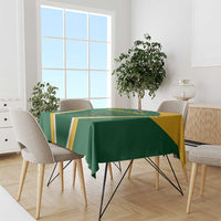 Green cricket-themed tablecloth with yellow-and-white stripes and border on dining table