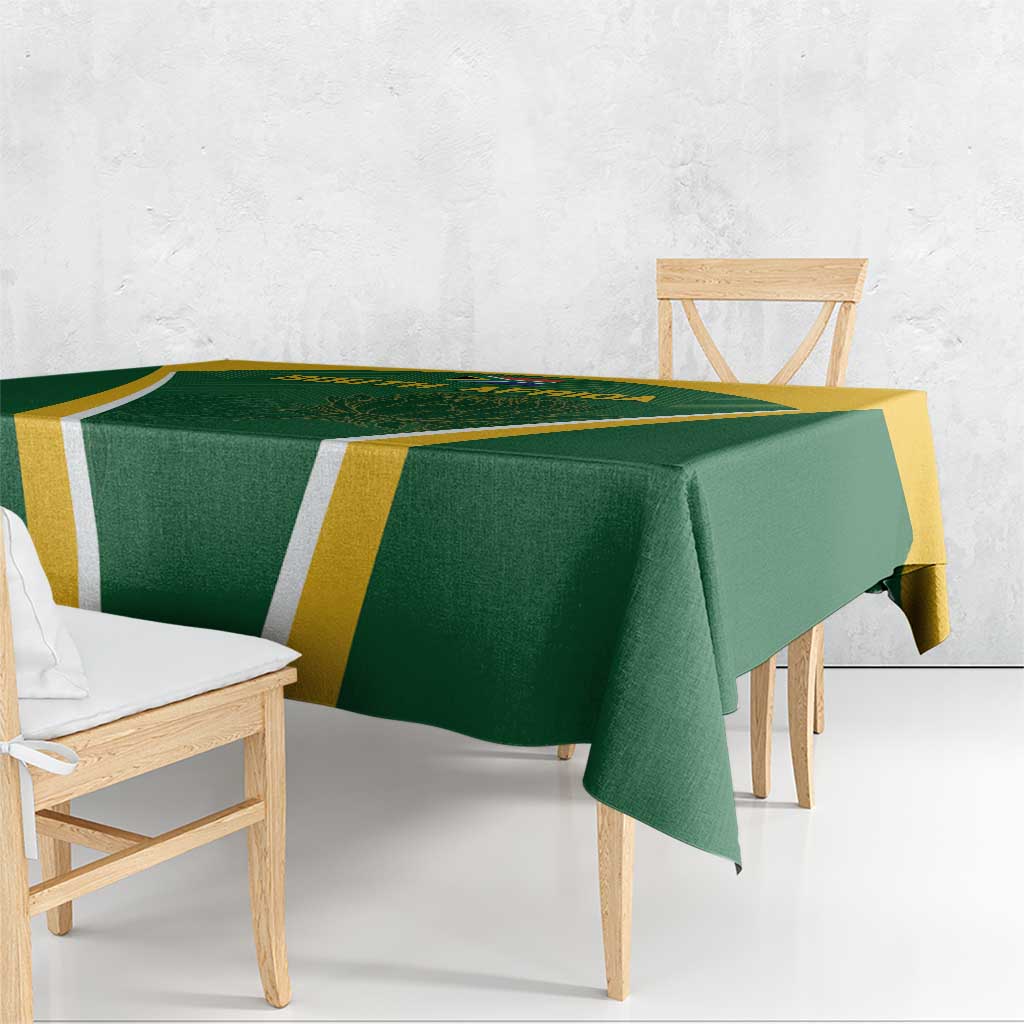 Green tablecloth with yellow and white geometric stripe pattern, neatly draped over bench
