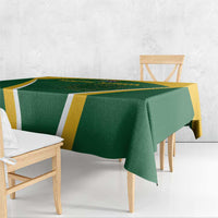 Green tablecloth with yellow and white geometric stripe pattern, neatly draped over bench
