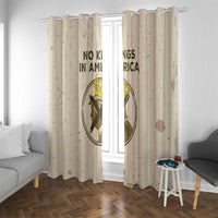 Beige window curtains with circular emblem and bold “NO KINGS IN AMERICA” text