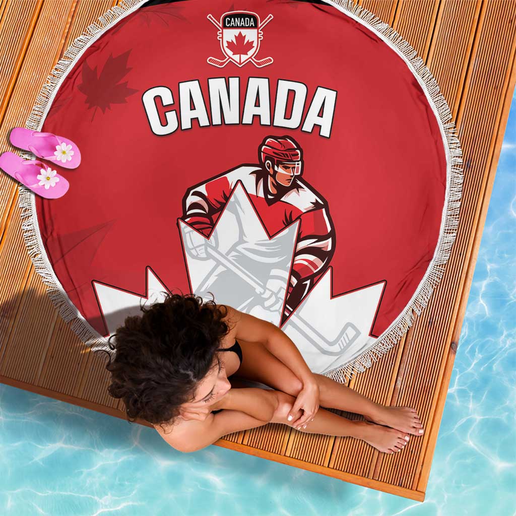 Red round beach blanket with Canada text, maple leaf logo, and white fringe