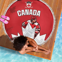 Red round beach blanket with Canada text, maple leaf logo, and white fringe