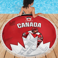 Round red beach blanket showing Canada hockey player graphic and white fringe border