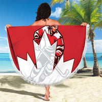 Red round beach blanket held up like a wrap, featuring Canada hockey player and white fringe