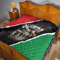 Libya-themed quilt laid on bed with black, red, and green diagonal border