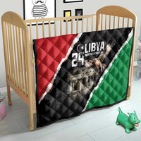 Libya-themed quilt on baby bed with black, red, and green diagonal design
