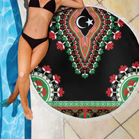 Round black dashiki beach blanket with fringe; vibrant floral border pattern on top