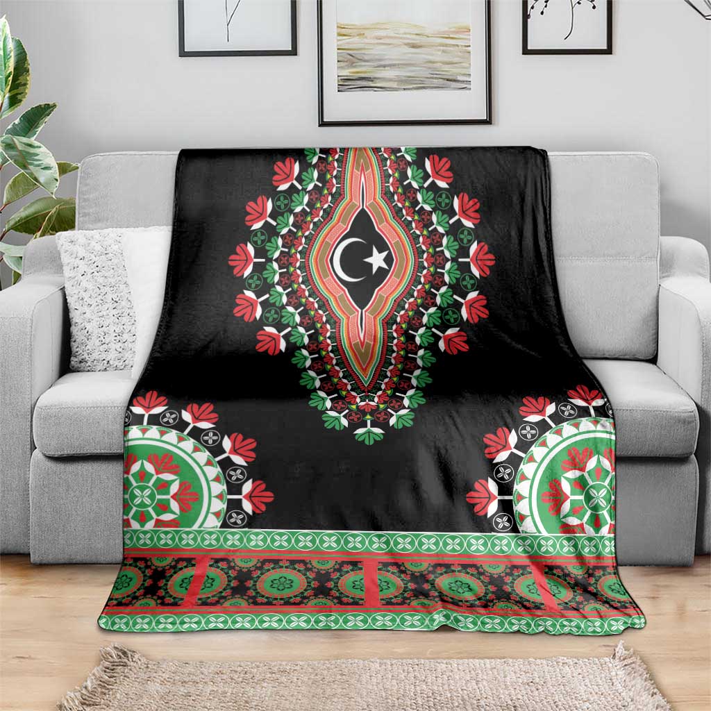 Black dashiki-style blanket on couch, crescent-star medallion with green-red corner motifs