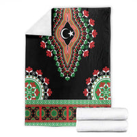 Black dashiki blanket folded with crescent-star medallion and green-red decorative trim