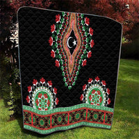 Black quilted throw blanket with arched patch panels, red-green florals, and central star motif.