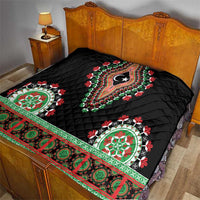 Black quilted bedspread with red-green floral band and central teardrop star design.