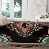 Black round carpet with central crescent-star design and red, green floral trim